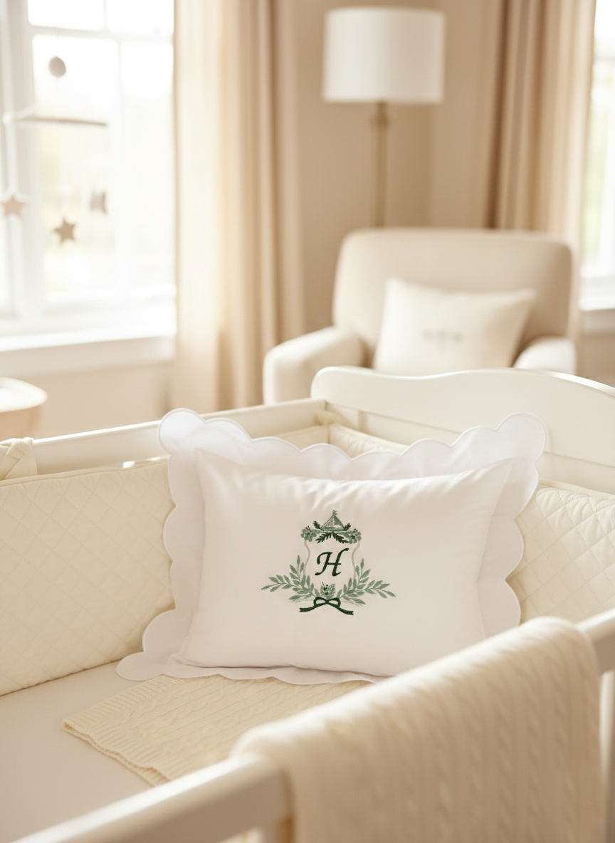 White pillow with a decorative emblem on a beige sofa in a bright living room.