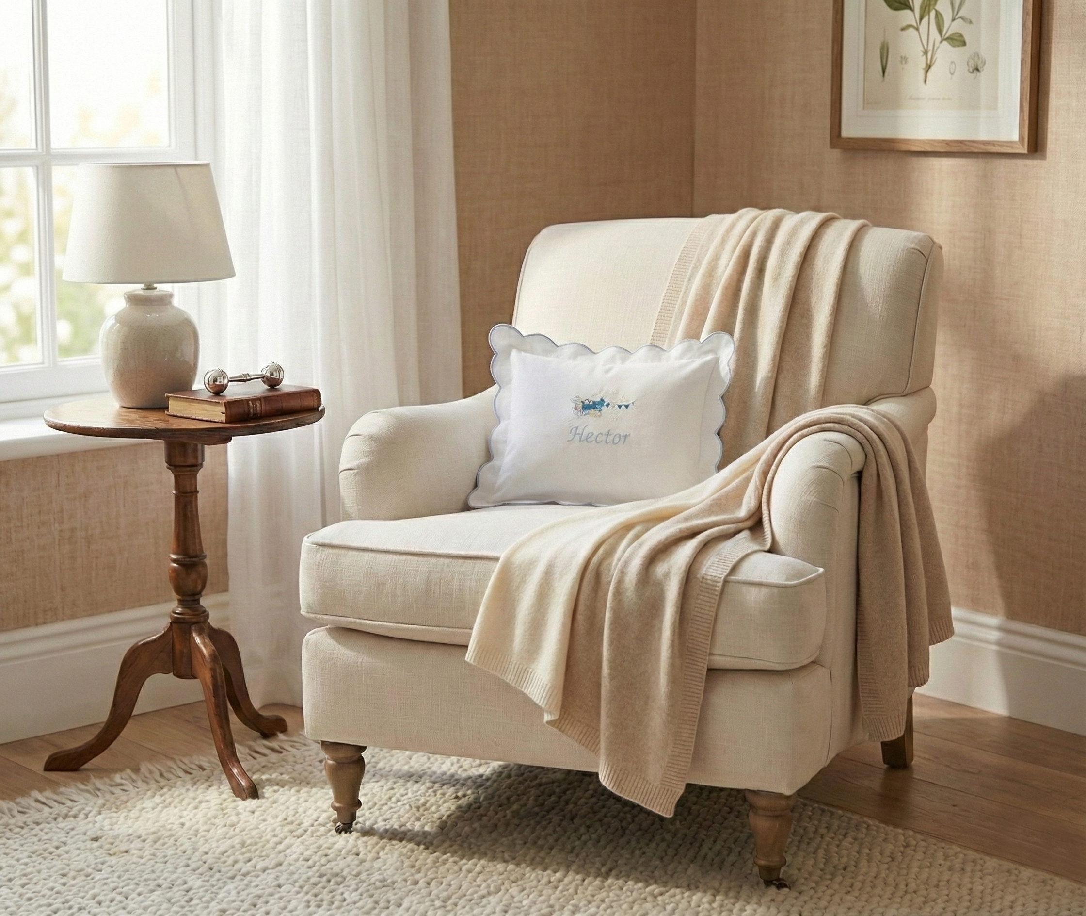 Beige armchair with a blanket and pillow in a cozy living room setting. Personalised baby pillowcase styled in living room, embroidered name cushion luxury baby gift idea