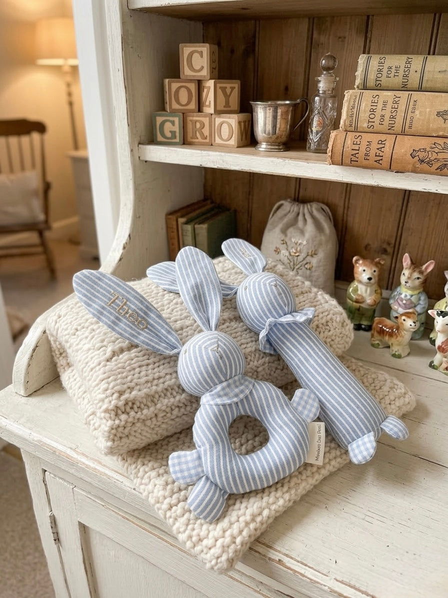 Decorative plush rabbit toys on a textured surface with a shelf in the background
