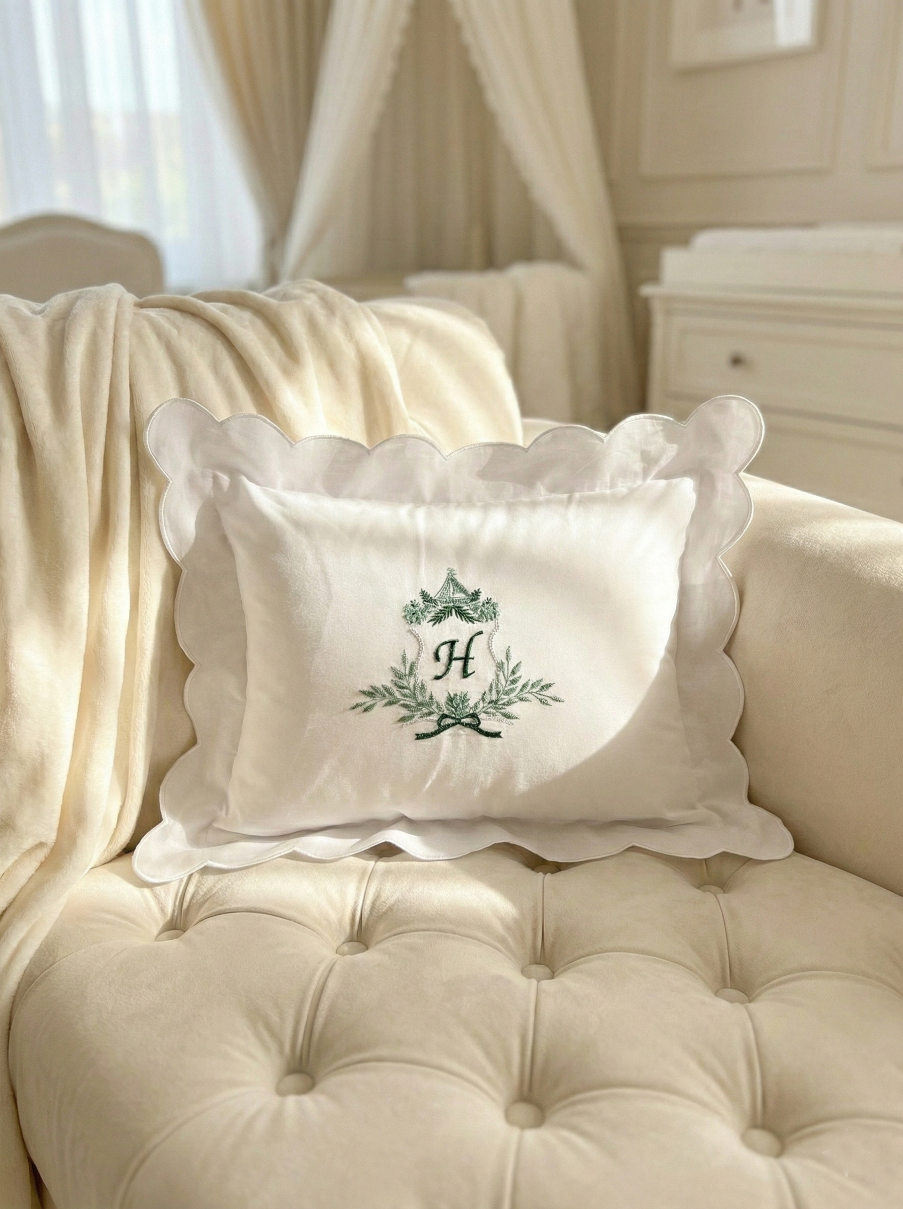 Decorative pillow with a monogram on a beige sofa